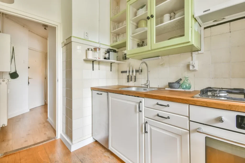 A modern kitchen with sleek cabinets, a large island, and bright lighting, showcasing renovation possibilities.